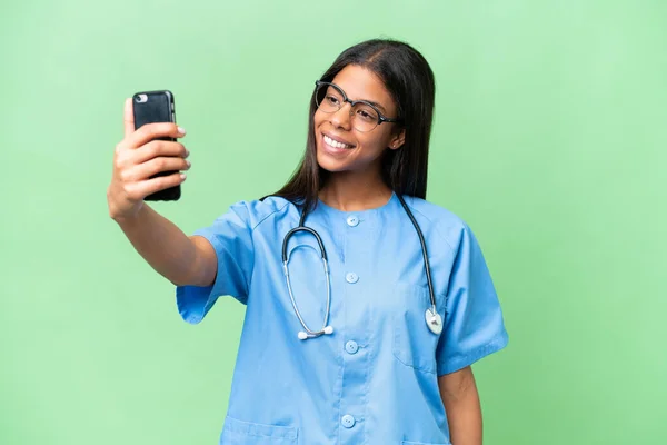 stock image Young African american nurse woman over isolated background making a selfie