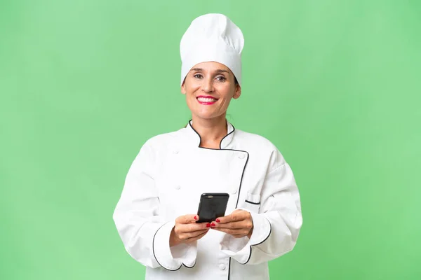 Middle Aged Chef Woman Isolated Background Sending Message Mobile —  Fotos de Stock