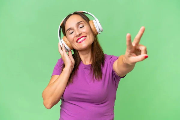 Middle Aged Caucasian Woman Isolated Background Listening Music Singing — Stock Photo, Image