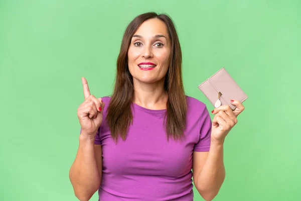 Middle Aged Caucasian Woman Holding Wallet Isolated Background Pointing Great — Stock Photo, Image