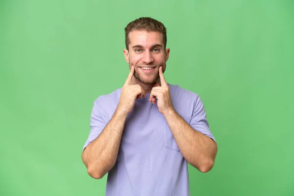 stock image Young handsome caucasian man isolated on green chroma background smiling with a happy and pleasant expression