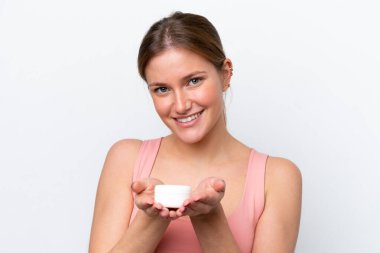 Beyaz arka planda nemlendirici ile izole edilmiş genç beyaz bir kadın.