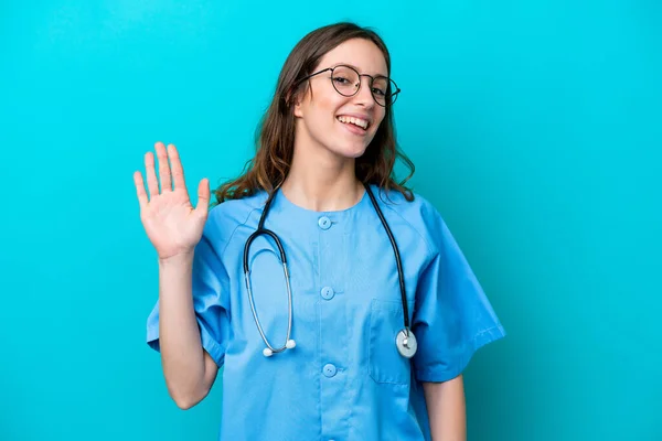 Young Surgeon Doctor Woman Isolated Blue Background Saluting Hand Happy — Stockfoto