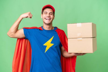 Super Hero delivery man over isolated background doing strong gesture