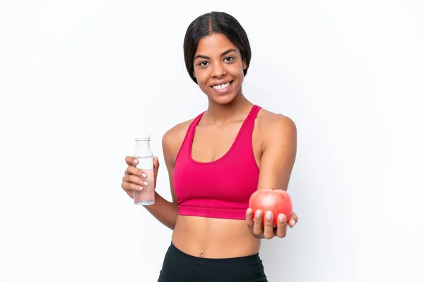 stock image Young African american woman isolated on white background with an apple and with a bottle of water