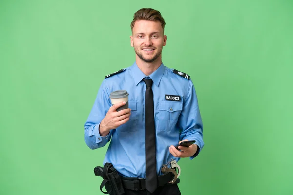 Молодий Поліцейський Над Ізольованим Тлом Тримає Каву Щоб Забрати Мобільний — стокове фото