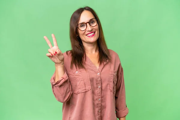 stock image Middle-aged caucasian woman over isolated background smiling and showing victory sign