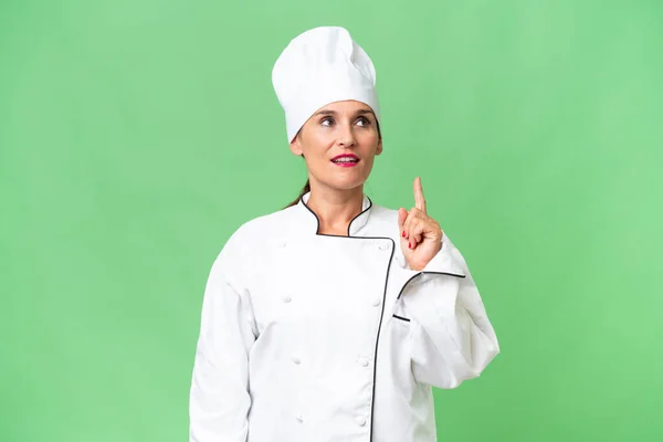 Middle Aged Chef Woman Isolated Background Thinking Idea Pointing Finger — Stock Photo, Image
