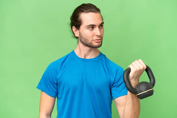 Young Handsome Man Isolated Green Chroma Background Making Weightlifting Kettlebell — Stock Photo, Image
