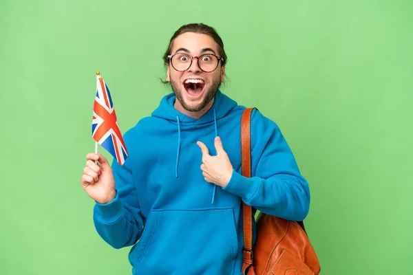 Mladý Pohledný Muž Drží Britskou Vlajku Nad Izolovaným Pozadím Překvapivým — Stock fotografie