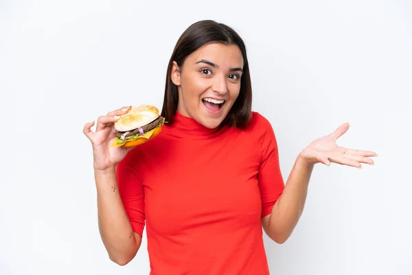 Young Caucasian Woman Holding Burger Isolated White Background Shocked Facial — Zdjęcie stockowe