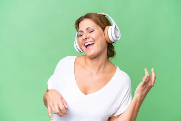 Middle Aged Caucasian Woman Isolated Background Listening Music Doing Guitar — Stock Photo, Image
