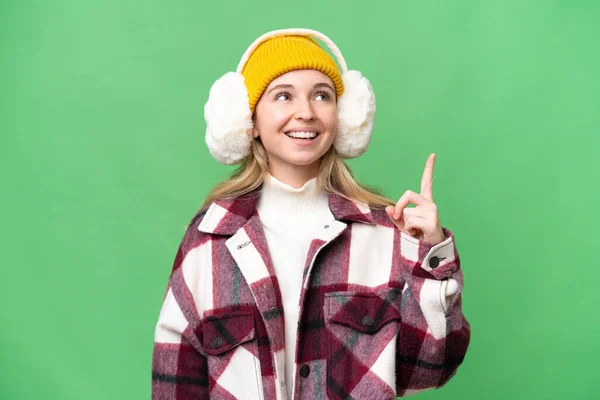 Young English Woman Wearing Winter Muffs Isolated Background Pointing Surprised — Stock Photo, Image