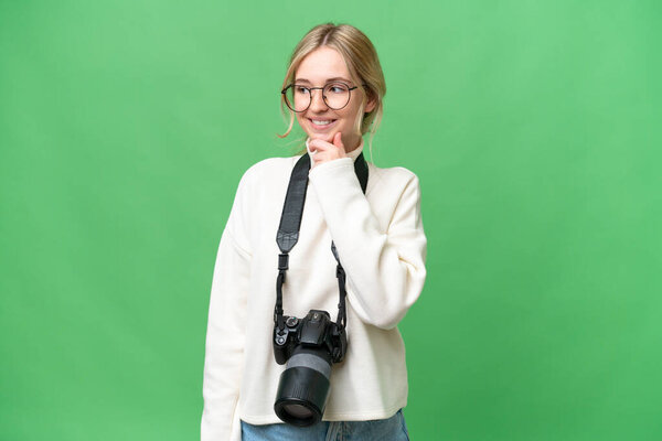 Young photographer English woman over isolated background looking to the side