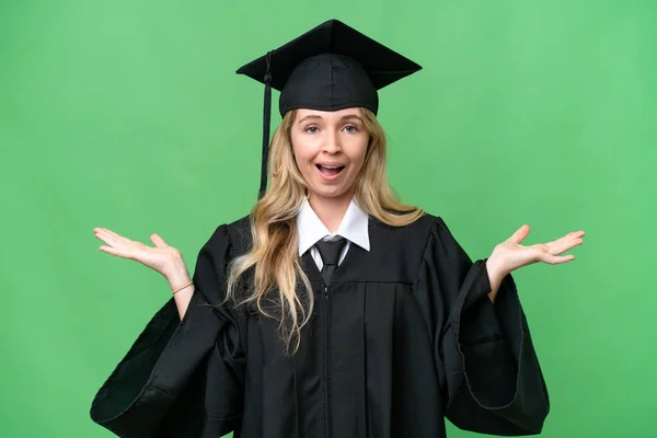 Young university English graduate woman over isolated background with shocked facial expression