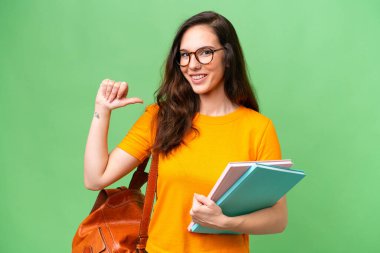 Young student caucasian woman over isolated background proud and self-satisfied