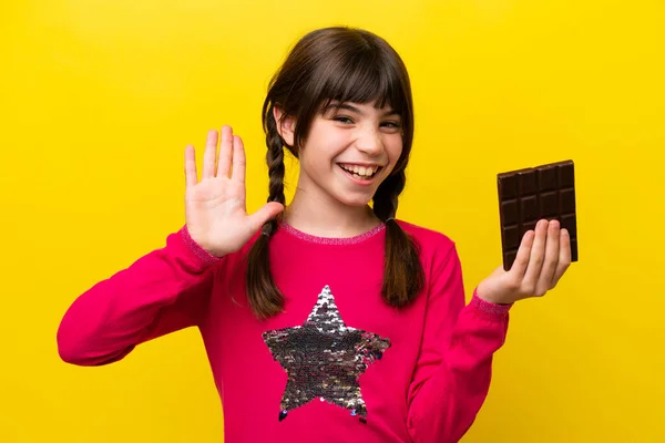 Malá Kavkazská Dívka Čokoládou Izolované Žlutém Pozadí Salutování Rukou Šťastným — Stock fotografie