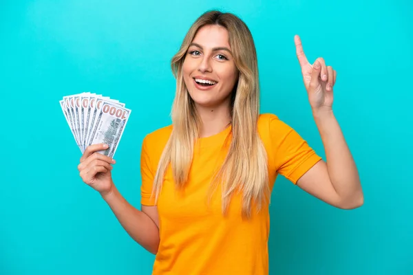 Young Uruguayan Woman Taking Lot Money Isolated Blue Background Showing — Stock Photo, Image