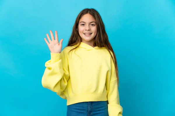 Klein Meisje Geïsoleerde Blauwe Achtergrond Salueren Met Hand Met Gelukkige — Stockfoto