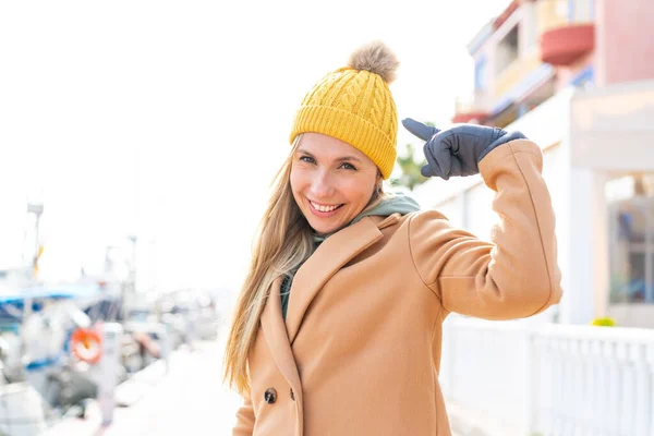 Молода Блондинка Носить Зимовий Піджак Відкритому Повітрі Вказує Нього — стокове фото