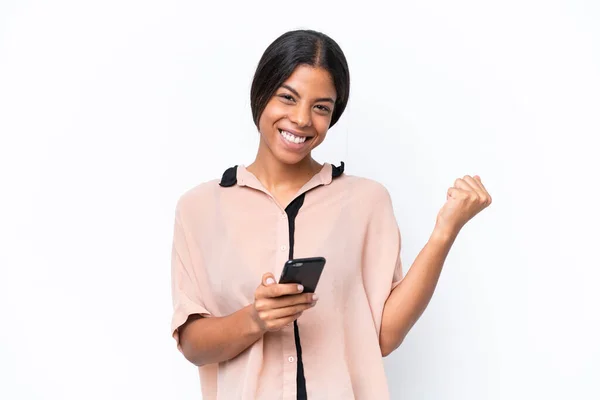 Stock image Young African american woman isolated on white background with phone in victory position