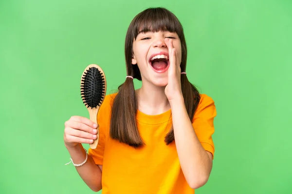 Little caucasian girl with hair comb over isolated background shouting with mouth wide open