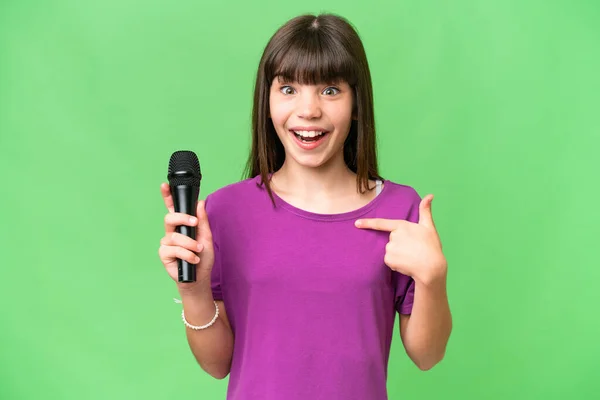 Little Singer Girl Picking Microphone Isolated Background Surprise Facial Expression — Stock Photo, Image