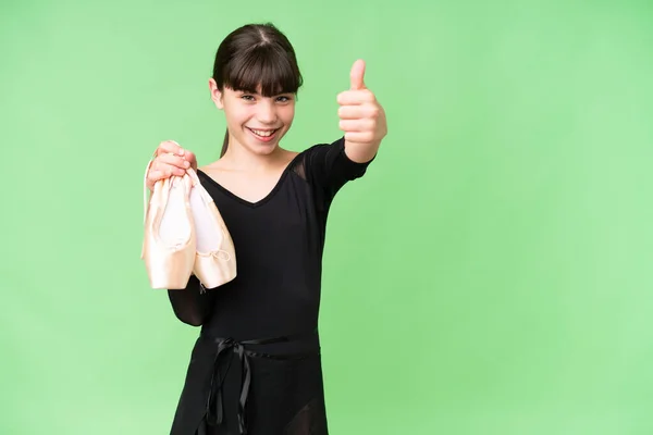 stock image Little caucasian girl practicing ballet over isolated background giving a thumbs up gesture