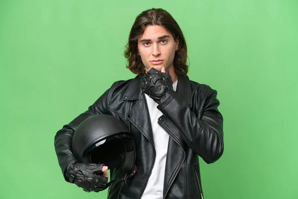 若いですハンサムな男とともにオートバイヘルメット隔離上の緑のクロマ背景思考 — ストック写真
