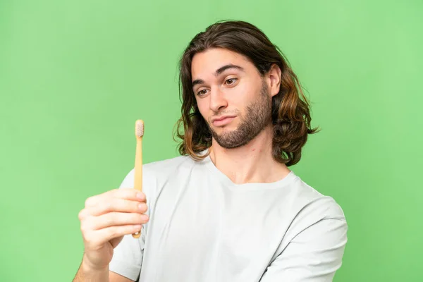 stock image Young handsome man brushing teeth over isolated background with sad expression