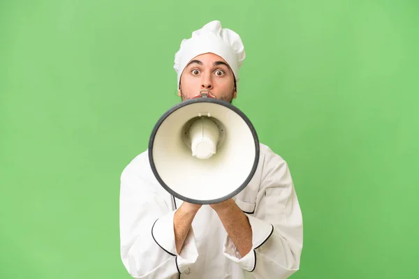 Młody Przystojny Szef Kuchni Człowiek Odosobnione Tło Krzyczy Przez Megafon — Zdjęcie stockowe