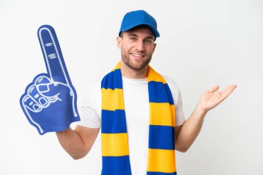 Young caucasian sports fan man isolated on white background extending hands to the side for inviting to come