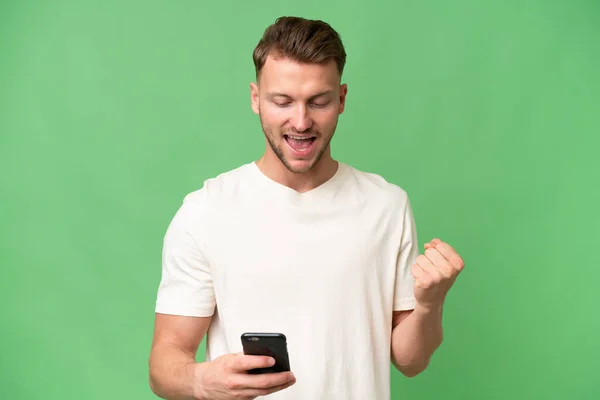 Young Blonde Caucasian Man Isolated Background Phone Victory Position — Stock Photo, Image
