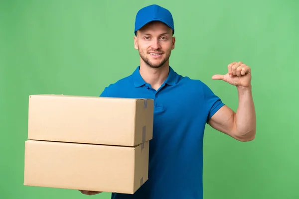 stock image Delivery caucasian man over isolated background proud and self-satisfied