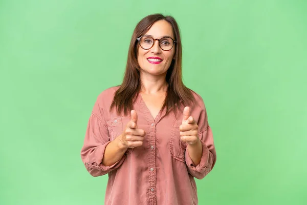 Stock image Middle-aged caucasian woman over isolated background pointing to the front and smiling