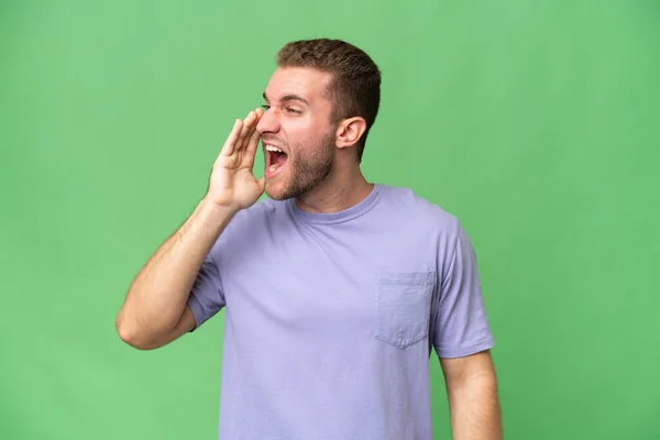 Young Handsome Caucasian Man Isolated Green Chroma Background Shouting Mouth — Stock Photo, Image