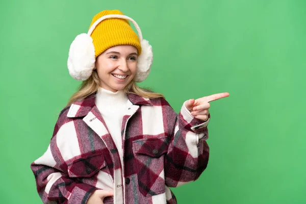 Young English Woman Wearing Winter Muffs Isolated Background Pointing Finger —  Fotos de Stock