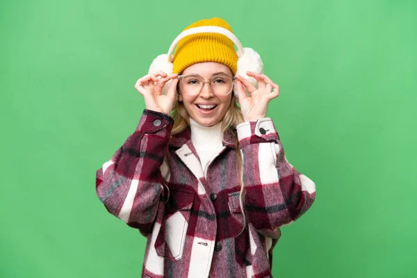 Young English Woman Wearing Winter Muffs Isolated Background Glasses Surprised — стокове фото