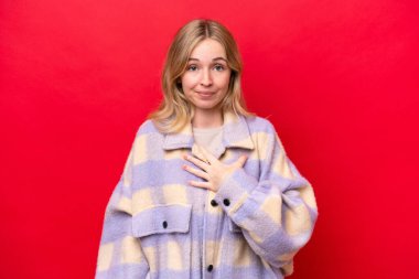 Young English woman isolated on red background pointing to oneself