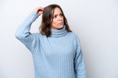 Beyaz arka planda soyutlanmış beyaz bir kadın. Kafasını kaşırken şüpheleri var.