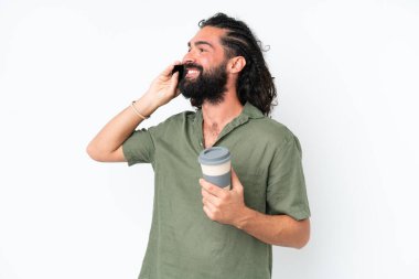 Young man with beard over isolated white background holding coffee to take away and a mobile