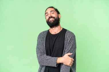 Young man with beard over isolated chroma key background laughing