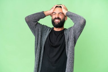 Young man with beard over isolated chroma key background laughing