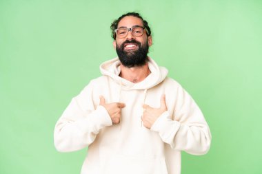 Young man with beard over isolated chroma key background with surprise facial expression