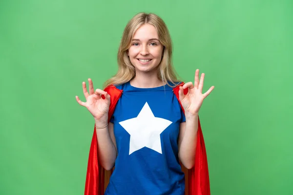 Super Hero English woman over isolated background showing an ok sign with fingers