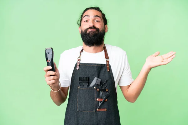 stock image Young barber man over isolated chroma key background having doubts while raising hands