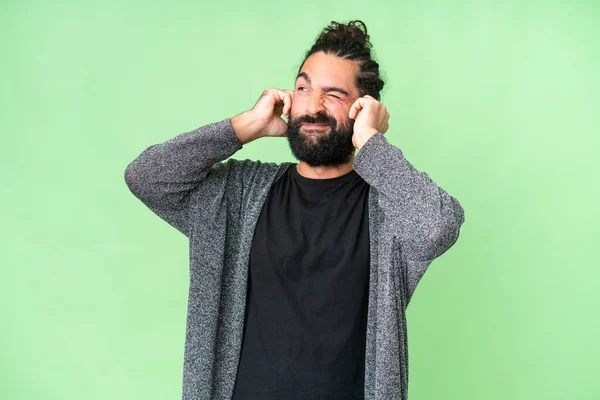 Young Man Beard Isolated Chroma Key Background Frustrated Covering Ears — Stok fotoğraf