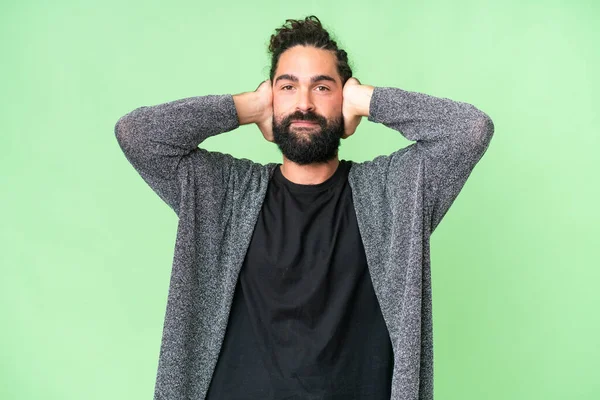 Young Man Beard Isolated Chroma Key Background Frustrated Covering Ears — Stockfoto