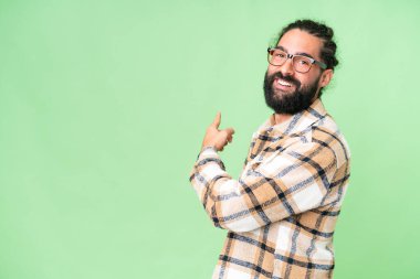 İzole edilmiş krom arka planda sakallı genç bir adam.