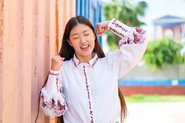 stock image Young Chinese woman at outdoors celebrating a victory